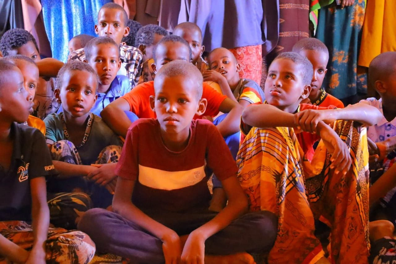 A portrait of a young girl in a blue school uniform